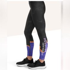 the legs of a person in black and blue leggings with words on them