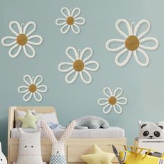 a child's bedroom decorated in blue and white with flowers on the wall above