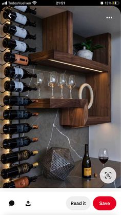 a wine rack filled with lots of bottles and glasses next to a wall mounted shelf