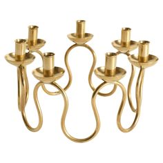 four brass candlesticks with twisted arms on a white background, set of three