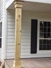 the front porch is covered with wood and has black shutters on both sides, along with a large wooden post