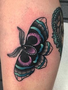 a colorful butterfly tattoo on the right thigh and lower leg, with an intricate design