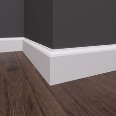 an empty room with wood flooring and black painted walls, along with white trim