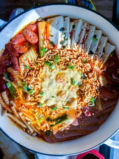 a bowl filled with noodles, meat and vegetables