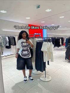 a woman taking a selfie in a clothing store