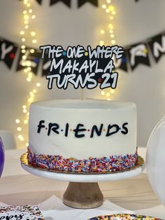 a birthday cake with the words friends written on it and sprinkles around it