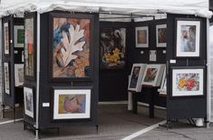 an outdoor booth with paintings and pictures on it