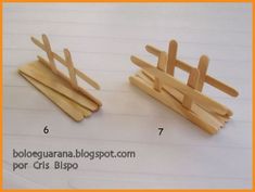 two wooden clothes pegs sitting next to each other on top of a white table