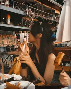 a woman sitting at a table eating food