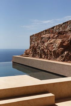 an outdoor swimming pool with steps leading to the water