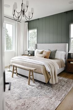 a bedroom with green walls and white bedding