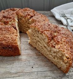 a sliced cake sitting on top of a wooden table