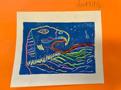 a child's drawing of a bird on a piece of paper