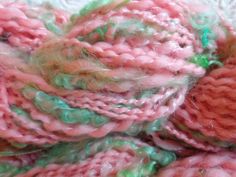 the yarn is pink, green and white