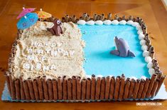 a birthday cake with a dolphin and beach scene on it