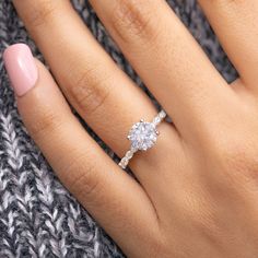 a woman's hand with a diamond ring on it