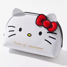 a hello kitty purse with a red bow on it