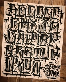 some type of calligraphy that is black and white with the letters written in it