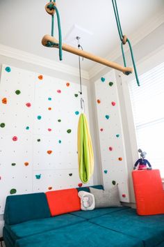 a living room filled with furniture and climbing walls