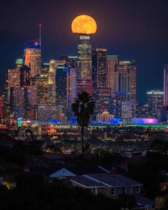 the full moon rises over los angeles, california