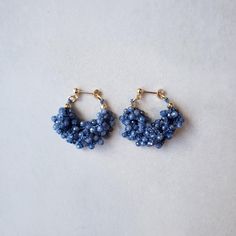 the beaded hoop earrings are blue and gold