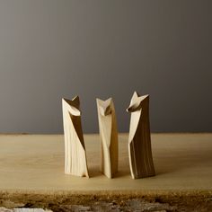 two wooden sculptures sitting on top of a table