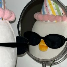 a penguin wearing sunglasses is reflected in a mirror