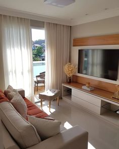 a living room filled with furniture and a flat screen tv