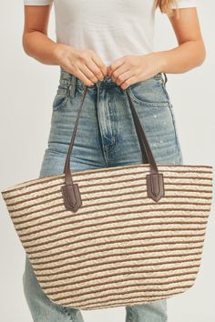 This Horizontal Stripe Straw Tote Bag is composed of woven straw and features a striking stripe pattern. It also comes with vegan leather straps and a full zipper closure for added security and convenience. The interior is lined with fabric which includes two internal pockets for easy storage. Its dimensions are 19" W X 13.5" T X 5.5" D, making it roomy enough for your daily items.65 Everyday Striped Straw Bag, Woven Striped Bags, Rectangular Striped Woven Shoulder Bag, Striped Woven Rectangular Shoulder Bag, Casual Striped Woven Bag, Striped Shoulder Bag With Braided Handles, Striped Woven Tote Bag, Striped Woven Straw Bag, Casual Striped Straw Bag