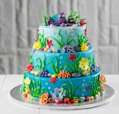 a three tiered cake decorated with under the sea theme