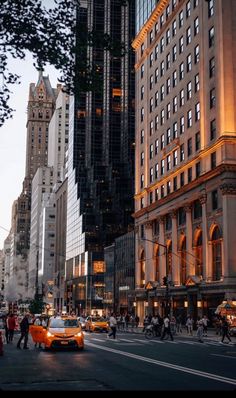 a city street filled with lots of traffic and tall buildings next to each other in the evening