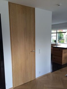 an empty room with wood floors and white walls is seen in this image from the doorway