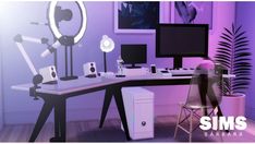 a computer desk sitting in front of a purple wall