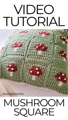 a green crocheted pillow with red flowers on it and the words video tutorial mushroom square