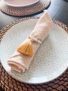 a white plate topped with a yellow tassel