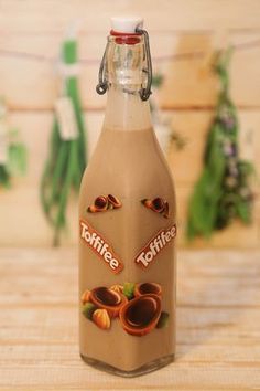 a glass bottle filled with liquid sitting on top of a wooden table