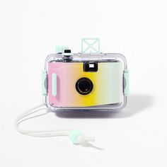 a camera that is sitting on top of a white surface with a string attached to it