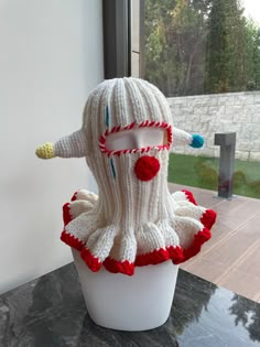 a knitted doll sitting on top of a table