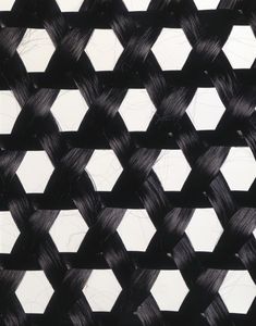 black and white photograph of woven material with hexagonal pattern on it's surface