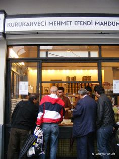 people are standing in front of a book store