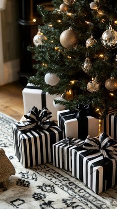 black and white wrapped presents under a christmas tree