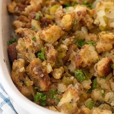 a casserole dish with stuffing and vegetables in it on a blue and white towel