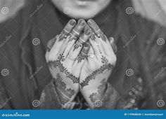 black and white photo of a woman with her hands folded in front of her face