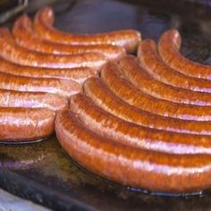 several sausages are being cooked in an oven