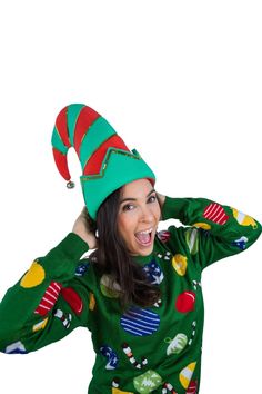 a woman wearing a green and red christmas sweater with an elf's hat on her head