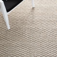 a white chair sitting on top of a rug