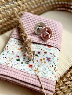 a close up of a piece of cloth with buttons on it and a plant in the middle