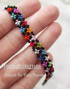 small multicolored beaded bracelet in the palm of someone's hand