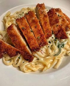 pasta with chicken and parmesan cheese on a white plate