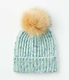 a blue and white hat with a brown pom - pom on the top